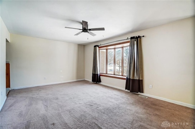 empty room with ceiling fan and carpet flooring