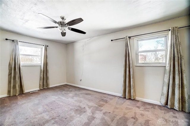 unfurnished room featuring light carpet and ceiling fan