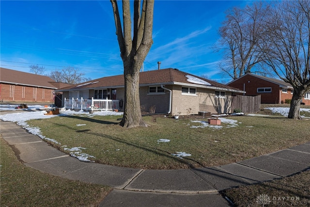 ranch-style home with covered porch and a front lawn