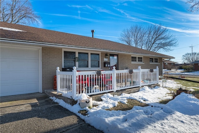 single story home featuring a garage and a porch