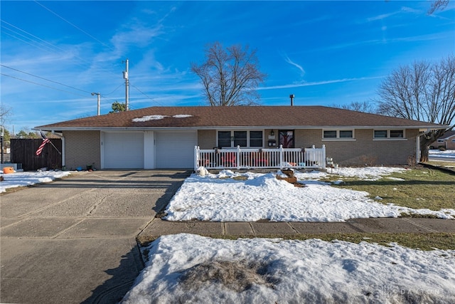 single story home with a porch and a garage