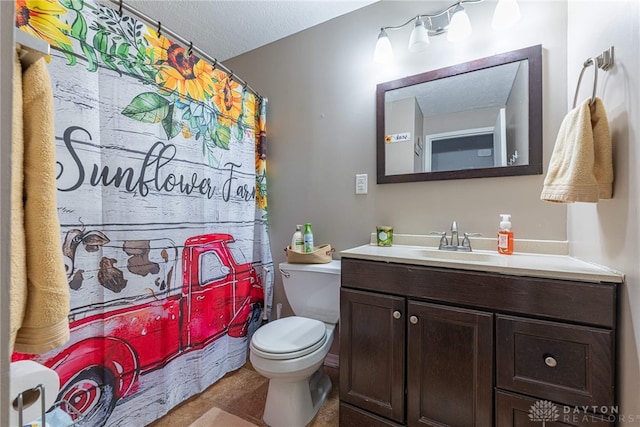 bathroom with vanity, a textured ceiling, and toilet