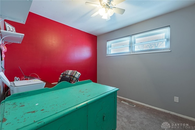 interior space with ceiling fan and carpet flooring