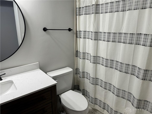 bathroom with vanity, a shower with shower curtain, and toilet