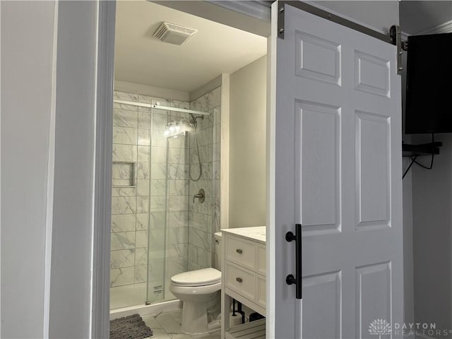 bathroom featuring vanity, toilet, and a shower with shower door