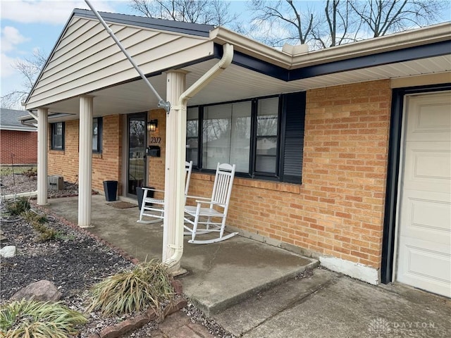 view of exterior entry with a porch