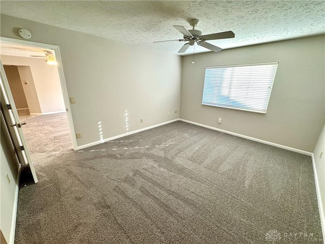 empty room featuring ceiling fan, carpet, and a textured ceiling