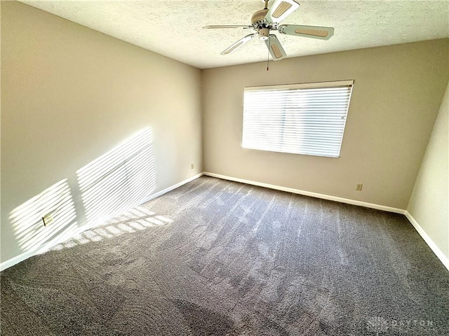 empty room featuring ceiling fan, carpet floors, and a textured ceiling