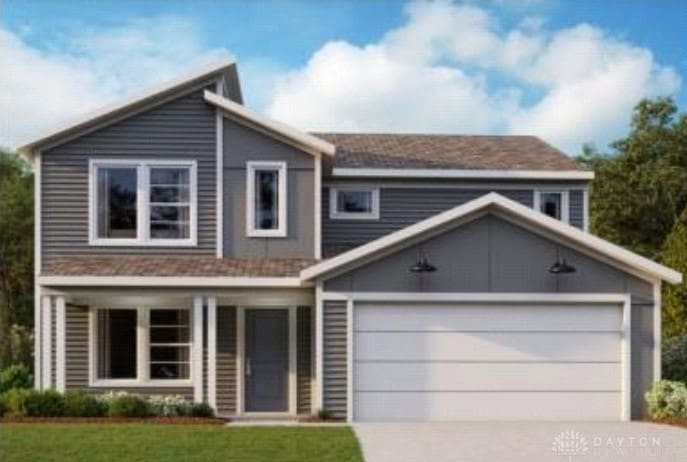 view of front facade with a garage and a front lawn