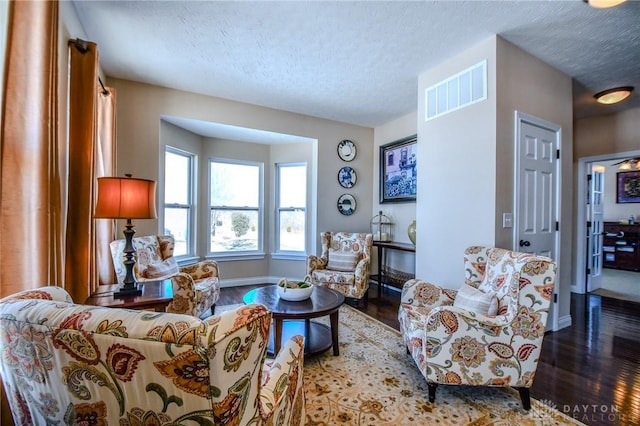 living room featuring hardwood / wood-style flooring and a textured ceiling