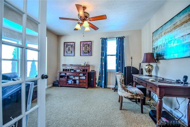 carpeted home office featuring ceiling fan and french doors