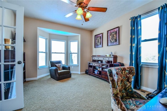 interior space featuring ceiling fan and a textured ceiling