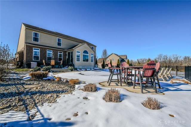 snow covered property with a playground