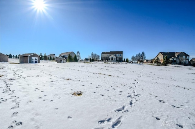 snowy yard with a storage unit