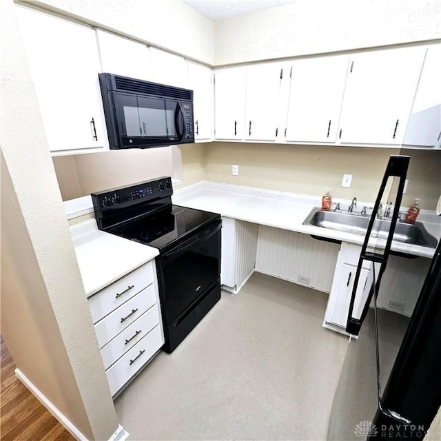 kitchen featuring white cabinetry, sink, light wood-type flooring, and black appliances