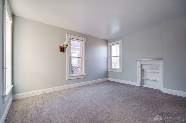 unfurnished living room featuring carpet floors