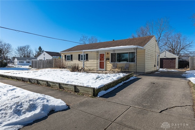 single story home featuring a garage and an outbuilding