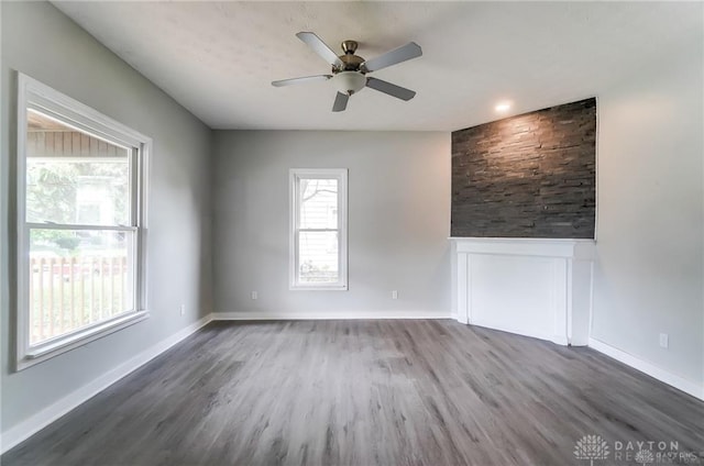 empty room with dark wood-type flooring and ceiling fan