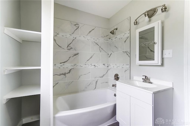 bathroom featuring vanity and tiled shower / bath