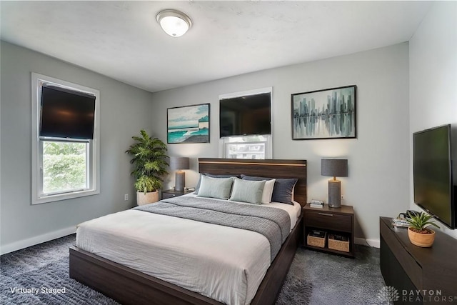 bedroom featuring dark carpet