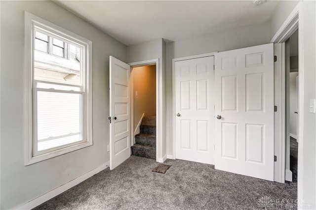 unfurnished bedroom with carpet floors and a closet