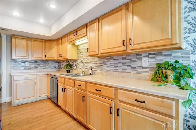 kitchen with sink, tasteful backsplash, light hardwood / wood-style flooring, light brown cabinets, and dishwasher