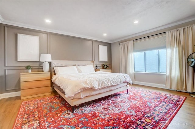 bedroom featuring crown molding and light wood-type flooring