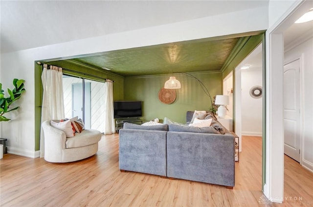 living room featuring crown molding and hardwood / wood-style flooring