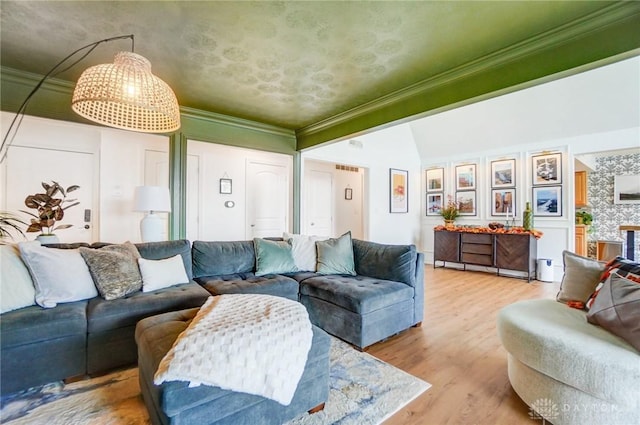 living room featuring ornamental molding, lofted ceiling, and light hardwood / wood-style floors