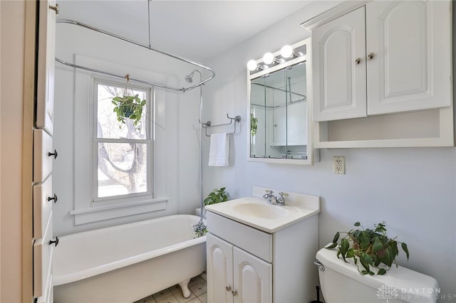 bathroom with vanity, toilet, and a bathing tub