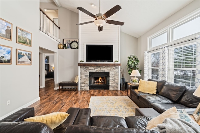 living room with ceiling fan, a fireplace, high vaulted ceiling, and wood-type flooring