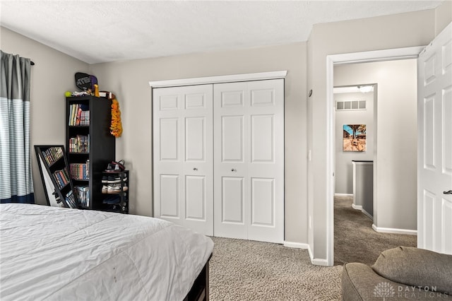 bedroom with carpet floors, a closet, and a textured ceiling