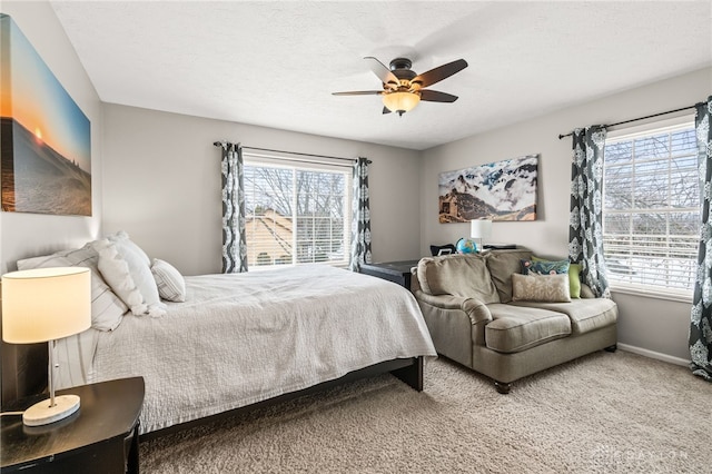 carpeted bedroom with a textured ceiling and ceiling fan