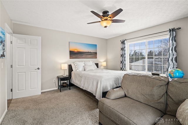 carpeted bedroom featuring ceiling fan and a textured ceiling