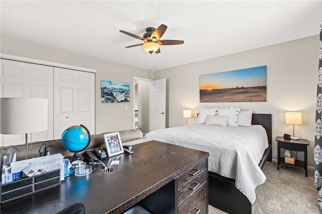 carpeted bedroom with ceiling fan and a closet