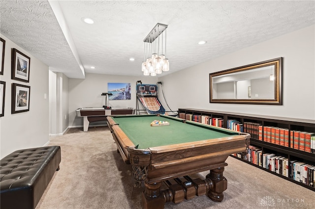 rec room featuring a textured ceiling and carpet flooring