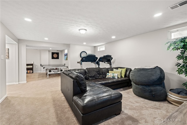 living room featuring light carpet and a textured ceiling