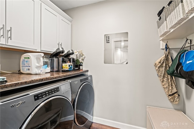 laundry room with cabinets and washer and clothes dryer