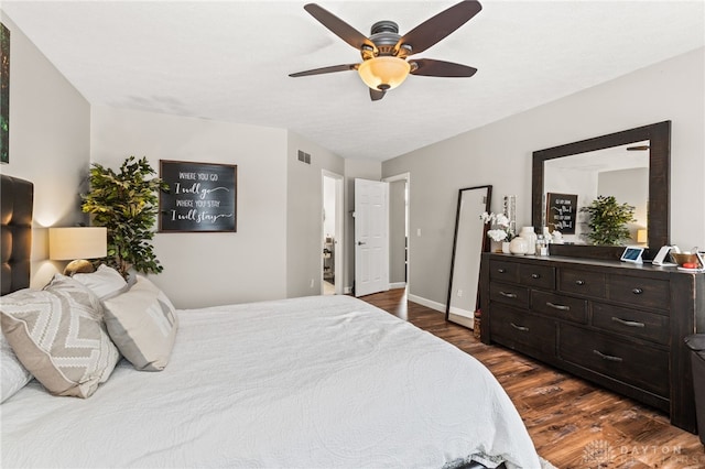 bedroom with ceiling fan and dark hardwood / wood-style flooring