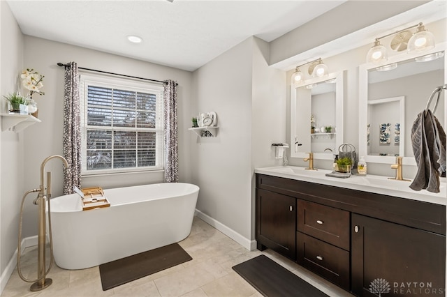 bathroom featuring vanity, a tub, and tile patterned floors