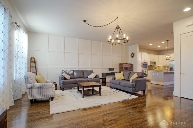 living room featuring dark hardwood / wood-style floors, sink, and a chandelier