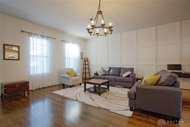 living room with an inviting chandelier and dark hardwood / wood-style flooring