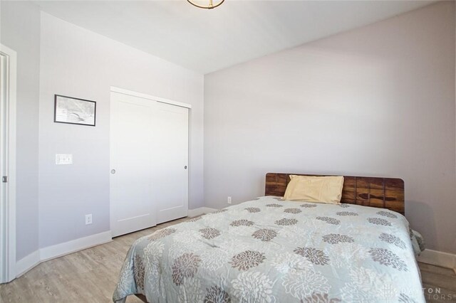 bedroom featuring light hardwood / wood-style flooring and a closet