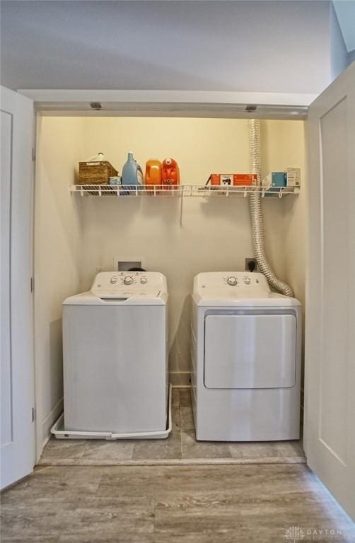 washroom featuring separate washer and dryer and wood-type flooring