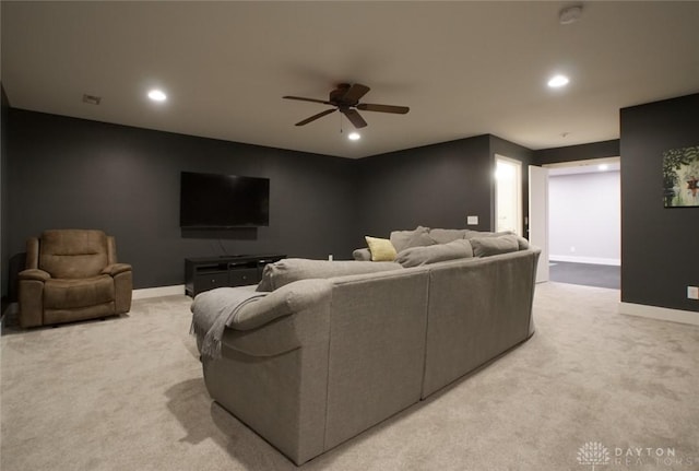 carpeted living room featuring ceiling fan