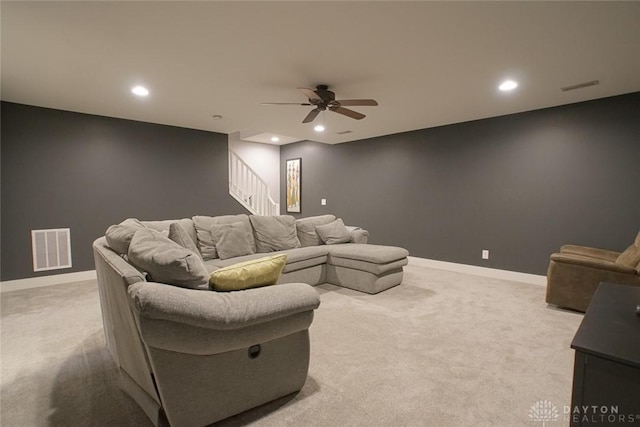 cinema featuring ceiling fan and light carpet