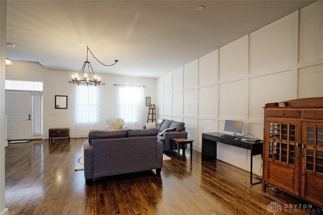 living room with an inviting chandelier and wood-type flooring