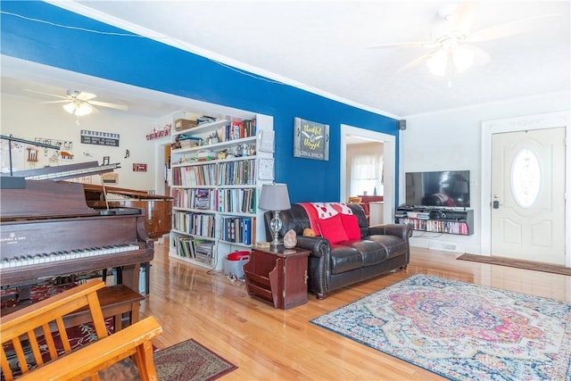 111 W Pinehurst St, Sidney, OH 45365 - living room featuring wood finished floors, ceiling fan, and crown molding