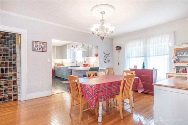 111 W Pinehurst St, Sidney, OH 45365 - dining room with ornamental molding, an inviting chandelier, and light wood-style floors