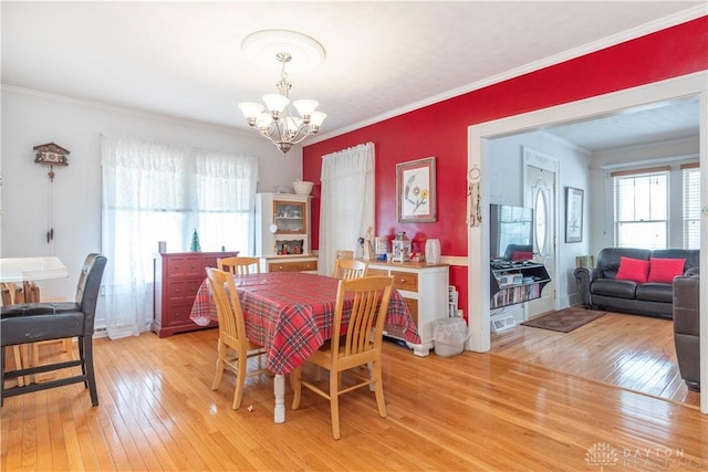 111 W Pinehurst St, Sidney, OH 45365 - dining room with crown molding, plenty of natural light, a notable chandelier, and light wood-style floors